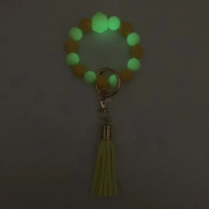 Bracciale portachiavi con perline luminose in silicone e nappa gialla effetto fluorescente