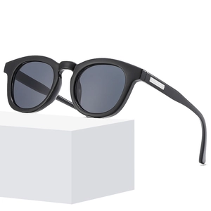 Classic round thick black frame sunglasses with dark grey lenses and silver metal temple detail