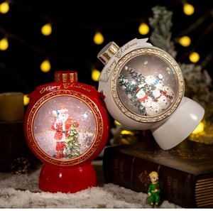 Detailed close-up of Christmas snow globes with Santa Claus and snowman miniatures