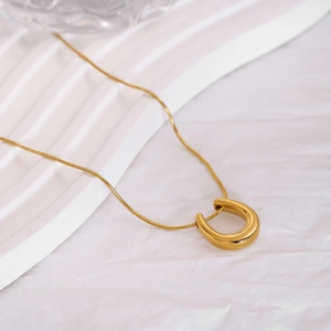 Minimalist gold titanium steel U-shaped horseshoe pendant necklace with sleek snake chain