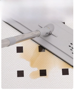 Detail showing the French style PVC door mat absorbing liquid with a mop on carpet