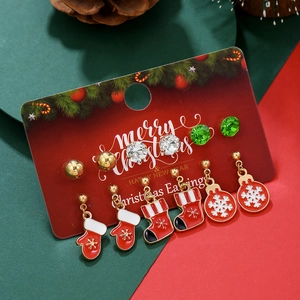 Detailed view of six pairs of Christmas stud earrings featuring snowflakes and elk patterns