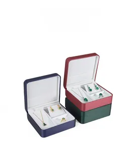 Detailed view of PU leather jewelry boxes in navy, burgundy, and green with velvet lining