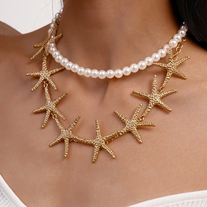 Detail of double-layer necklace with white pearls and gold starfish pendants on a model