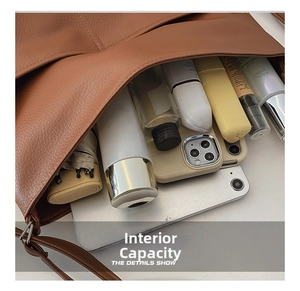 Top view of spacious brown leather tote bag interior showing capacity for tablets and umbrellas