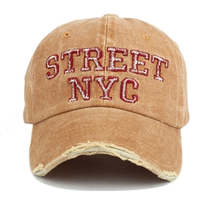 Detail of distressed brim and red 3D embroidery on vintage khaki washed cotton cap