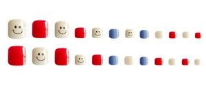 Flat lay of red, white and blue press-on toenails with cute black smiley face designs