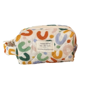 Quilted fabric cosmetic bag with colorful U-pattern, zipper closure and side handle
