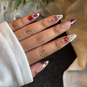 Long almond press-on nails with cherry art, leopard patterns and gold bead accents