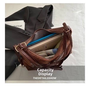 Spacious interior of brown suede tote bag showing capacity for books and daily essentials