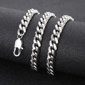 Detail of silver Cuban link chain with lobster clasp on a black textured stand