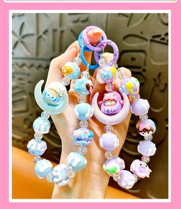 Detailed close-up view of cute moon beaded keychain and handmade phone charm accessory