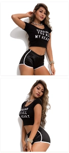 Detail view of black cropped tee and matching side-striped sports shorts with white trim