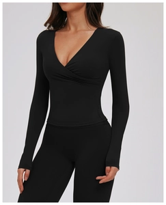 Close-up of black V-neck wrap yoga shirt showing slim fit fabric and sewing details