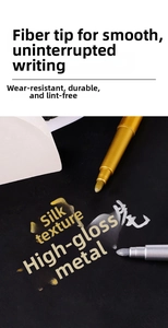 Detail of gold and silver metallic markers writing on black paper with smooth fiber tips