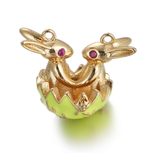 Detailed view of golden Easter bunny charm with red eyes in a green enamel egg shell