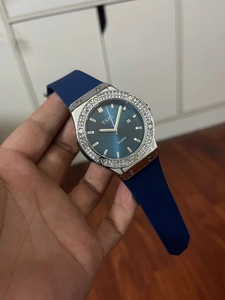 Detail of blue quartz watch featuring a rhinestone bezel and flexible silicone strap