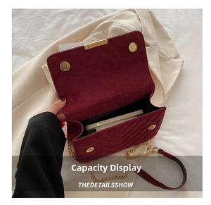 Detail of burgundy velvet chain bag showing internal capacity for a smartphone