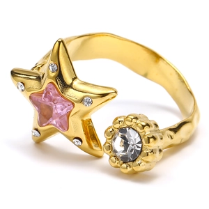 Star-shaped gold ring with pink zircon and white crystal stones on a textured band