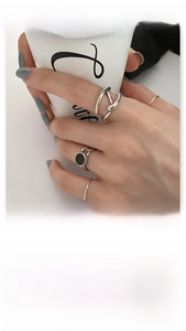 Detail view of S925 sterling silver irregular crisscross rings with black enamel inlay