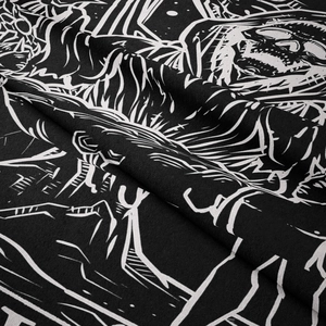 Macro shot of gothic black and white tapestry fabric with detailed skull pattern and texture