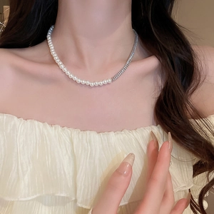 Close-up of pearl and zircon patchwork necklace worn on a model's collarbone