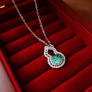 Elegant silver Wu Lou pendant necklace with green gemstone in a red velvet gift box