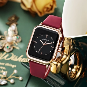 Detailed view of women's quartz watch with burgundy silicone strap and square rose gold case