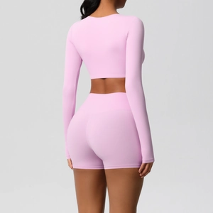 Back view of light pink long sleeve yoga crop top and high waist fitness shorts set