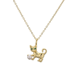 Golden cat pendant necklace with green zircon eyes and a white pearl on white background
