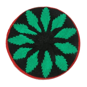 Detail of crochet beanie featuring green leaf patterns and red stitched hem on black knit