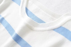 Detail shot of the ribbed round neckline and high-density striped knit fabric texture