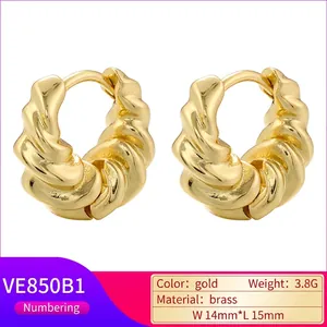 Gold twist croissant hoop earrings in textured brass with vintage minimalist style