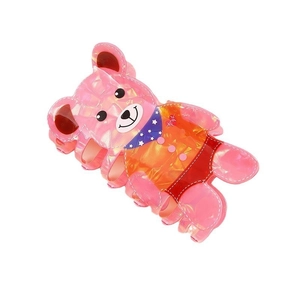 Detailed view of a pink bear hair claw clip with pearlescent finish and orange outfit