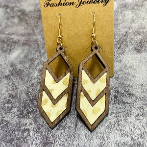 Detailed view of leopard print geometric wooden earrings on a jewelry display card