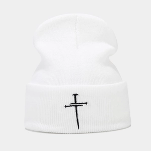 White knitted beanie featuring black cross embroidery detail for a retro unisex street style
