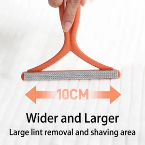 Manual lint remover with 10cm wide head and orange handle for fabric hair cleaning