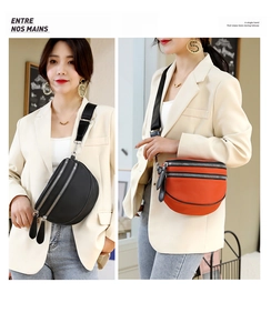 Detail view of double-layer zipper compartments on a stylish nylon crescent crossbody bag