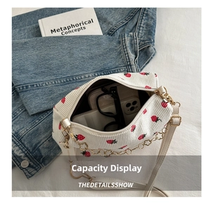 Internal storage view of white strawberry embroidery corduroy bag with heart chain detail