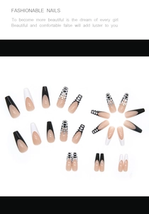 Detail of long ballerina press-on nails with black cross charms and french tips
