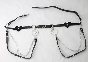 Detail of gothic punk PU leather body harness with silver rings and heart pendant