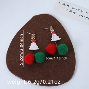 Macro view of asymmetric Christmas earrings showing size and weight specs in inches