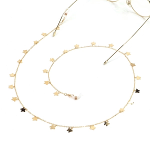 Detailed view of a golden metal eyewear chain with delicate butterfly charms and loops