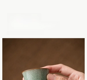 Detail of hand-drawn Ru kiln celadon tea cup with ice crackle glaze and brown rim