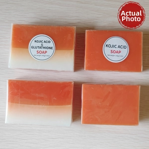 Detail of 140g Kojic Acid and Glutathione soap bars on a light wooden background