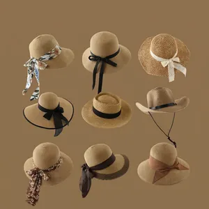 Collection of straw sun hats with wide brims and decorative ribbons in a grid display