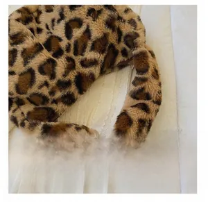 Detail presentation of the soft faux fur leopard print handle on this stylish small handbag