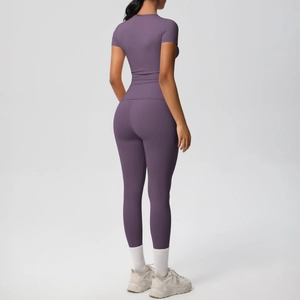 Rear view of women's purple slim fit yoga set showing seamless fabric and elastic fit