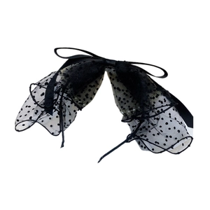 Detailed view of elegant black polka dot mesh bow headband with sheer tulle texture