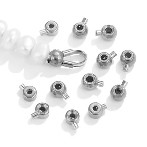 Silver stainless steel positioning bead clamps for jewelry making displayed with pearls